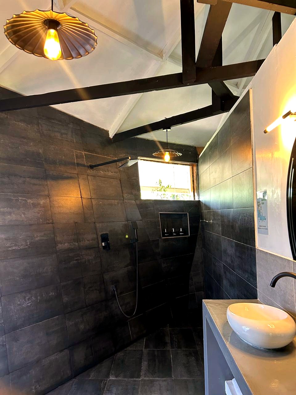 Slate-tiled walk-in shower and vanity