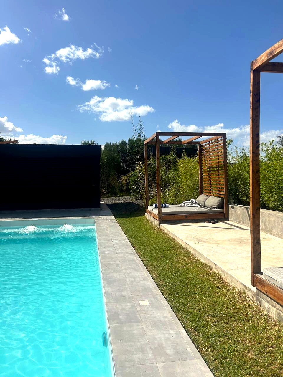 Poolside daybed and pergola lounge