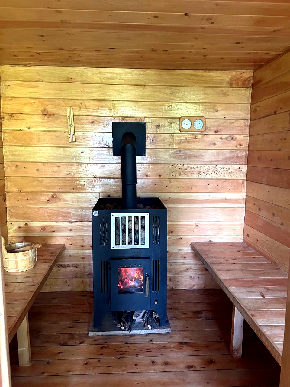 The on-site wood-fired sauna, with heated stones and cedar benches